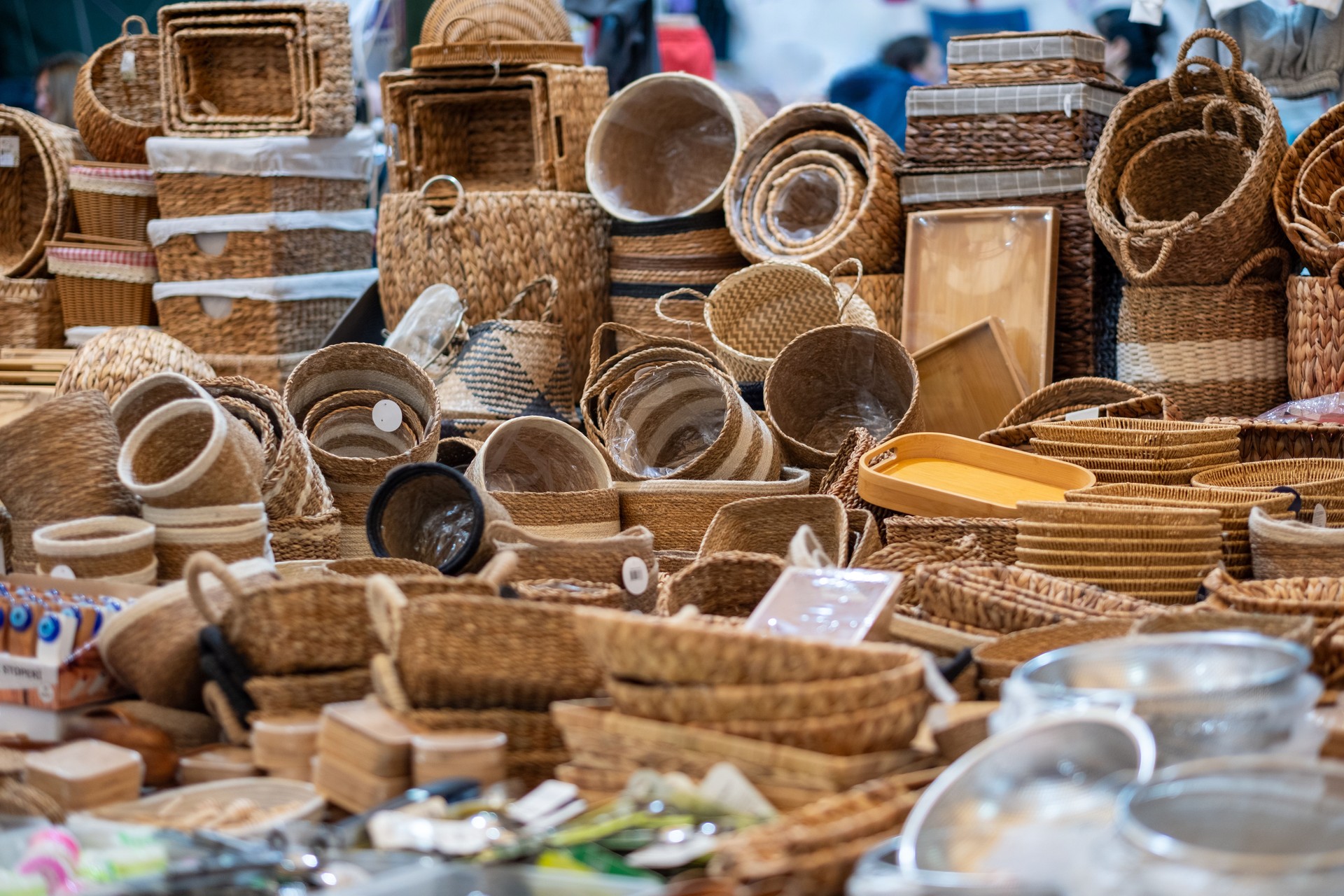 Wicker baskets and trays for sale at a market stall displaying traditional craftsmanship